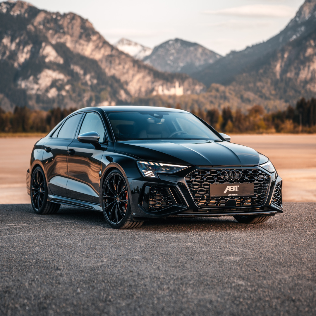 Black ABT RS3-S from the side front view in front of a large mountain panorama