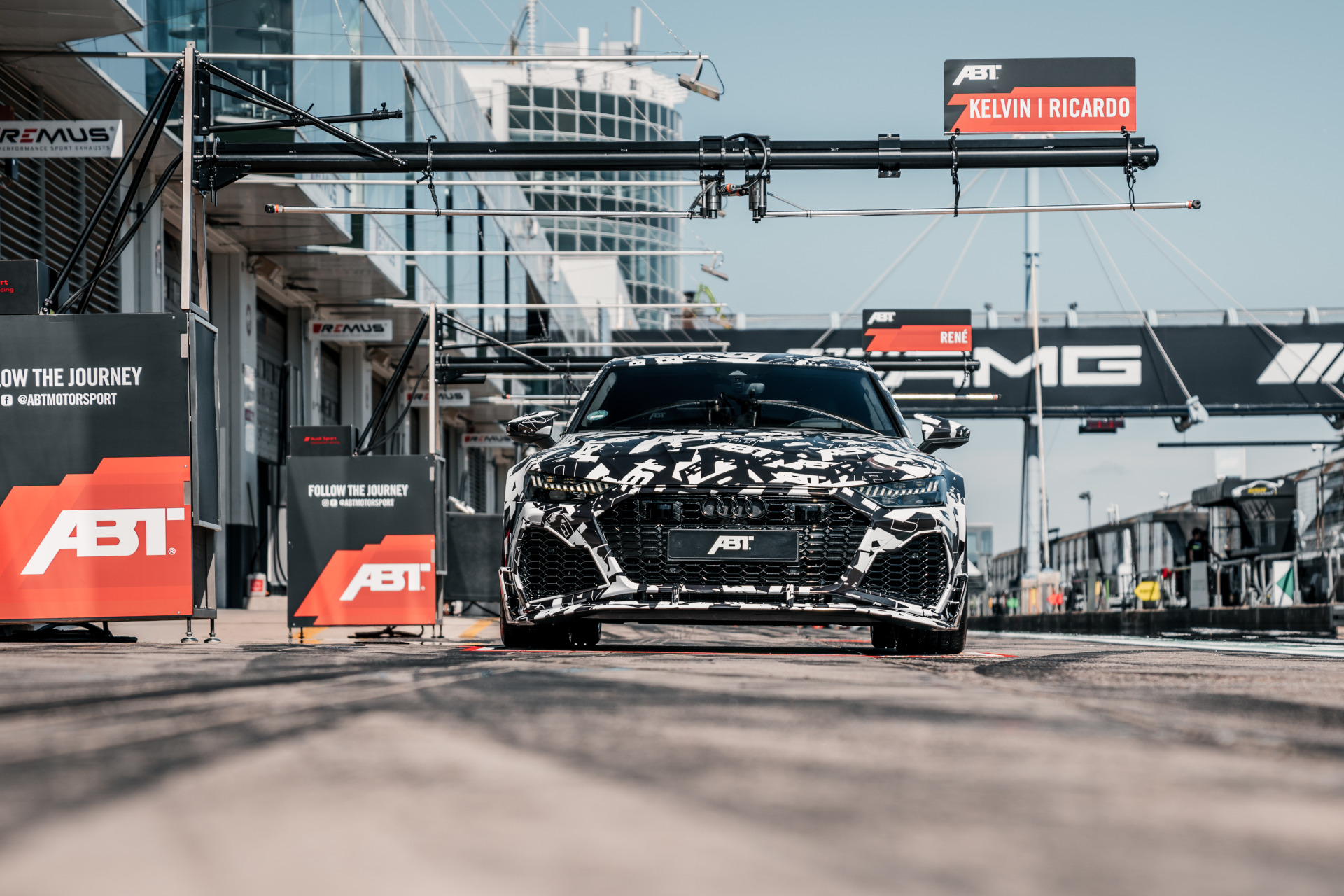 black, white RS7-LE-1000 PS from the front view during a pit stop on the race track